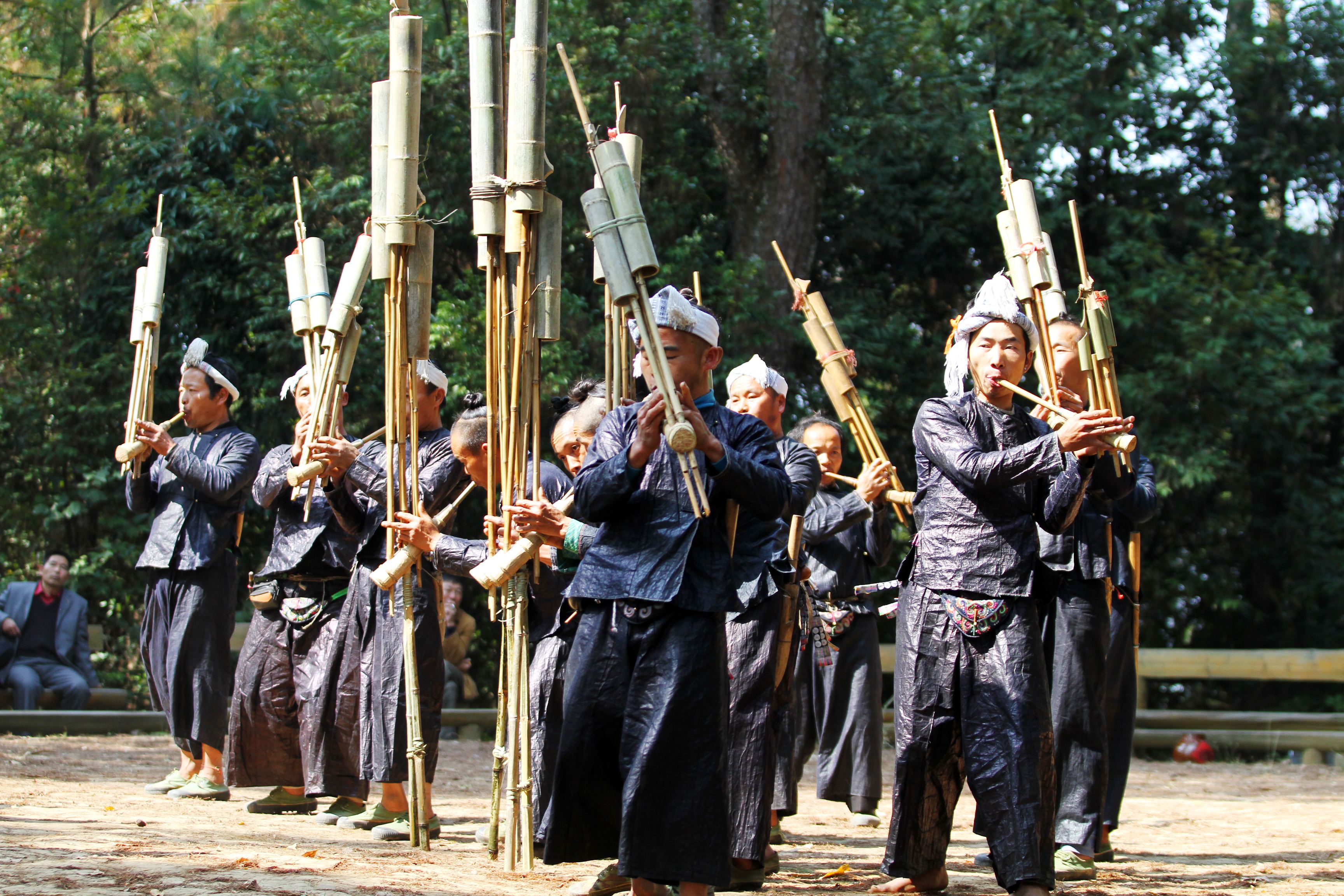 Basha Miao men with their traditional topknots and guns