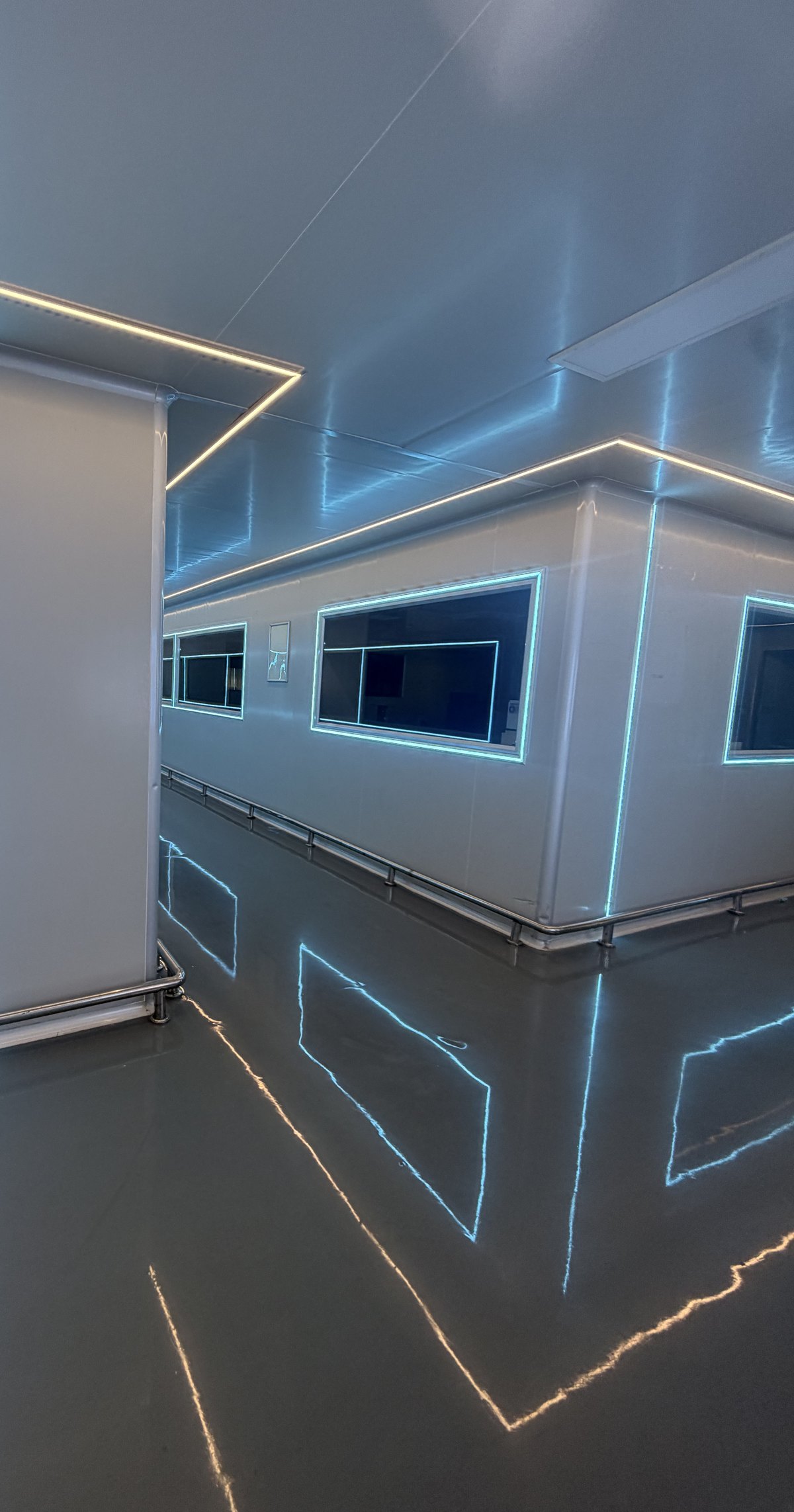 Cleanroom corridor with reflective floor and strip lighting