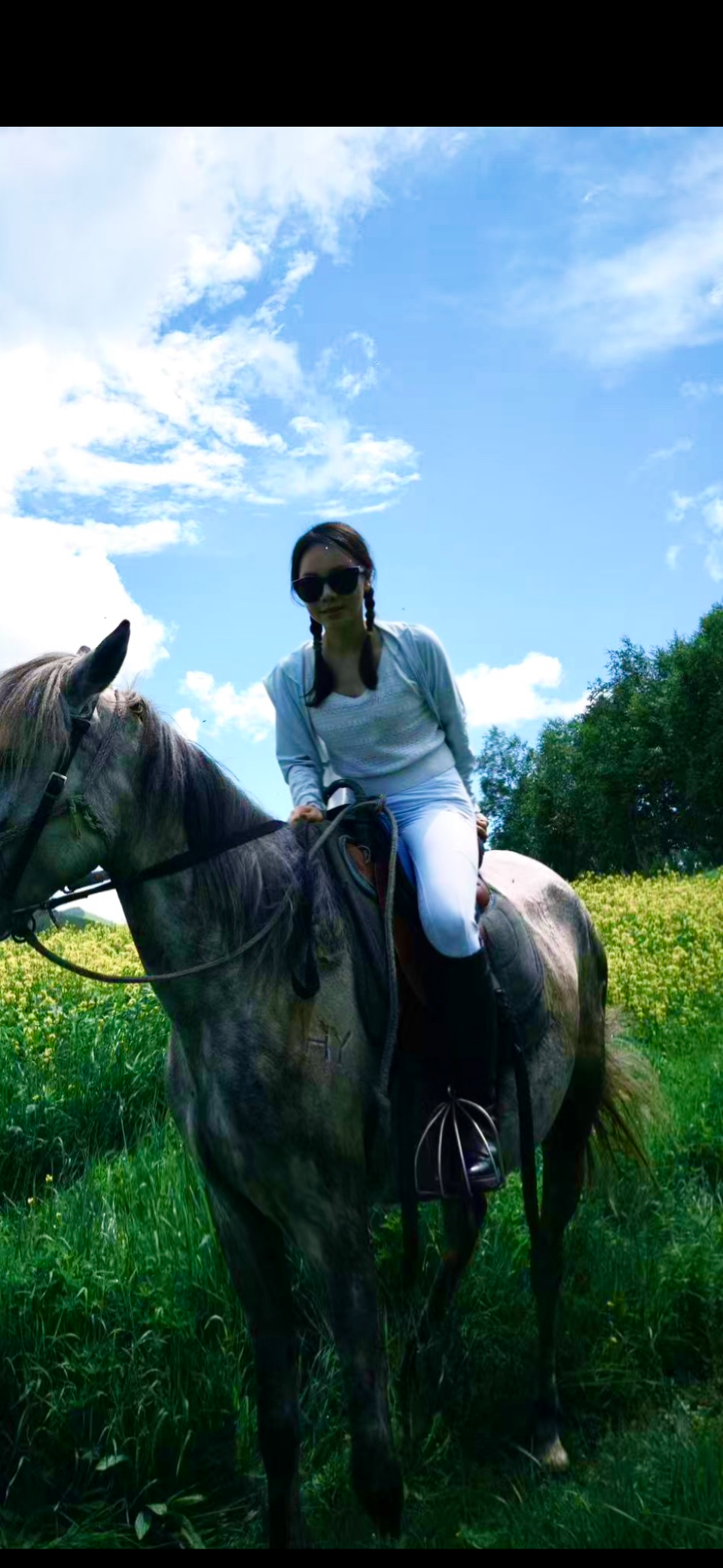 Lumi on horseback, blue skies