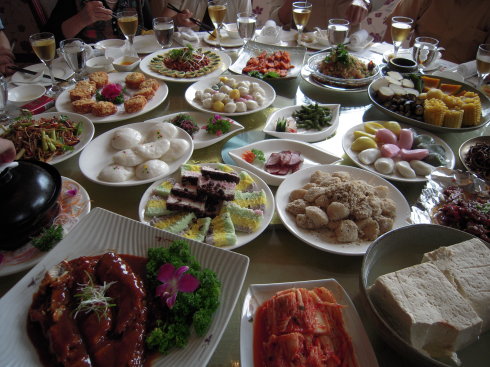 Korean-Chinese table spread with kimchi and rice cakes, Yanbian