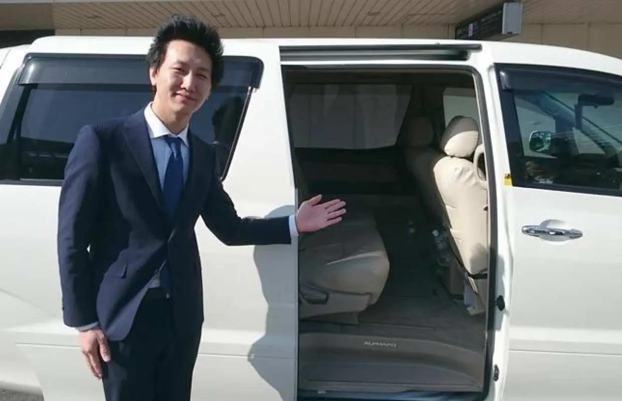 Professional driver-guide opening the car door