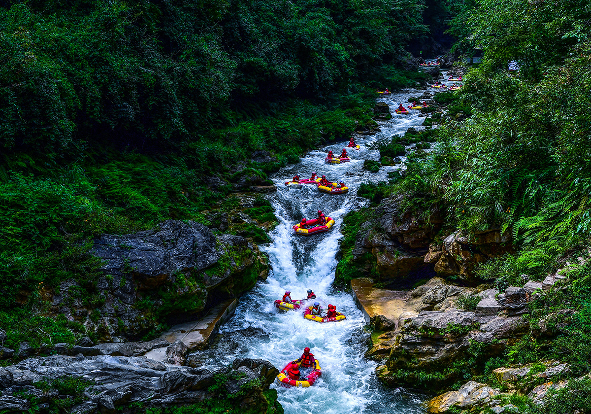 Rafting through the forested gorge of Gaoguohe near Zhenyuan