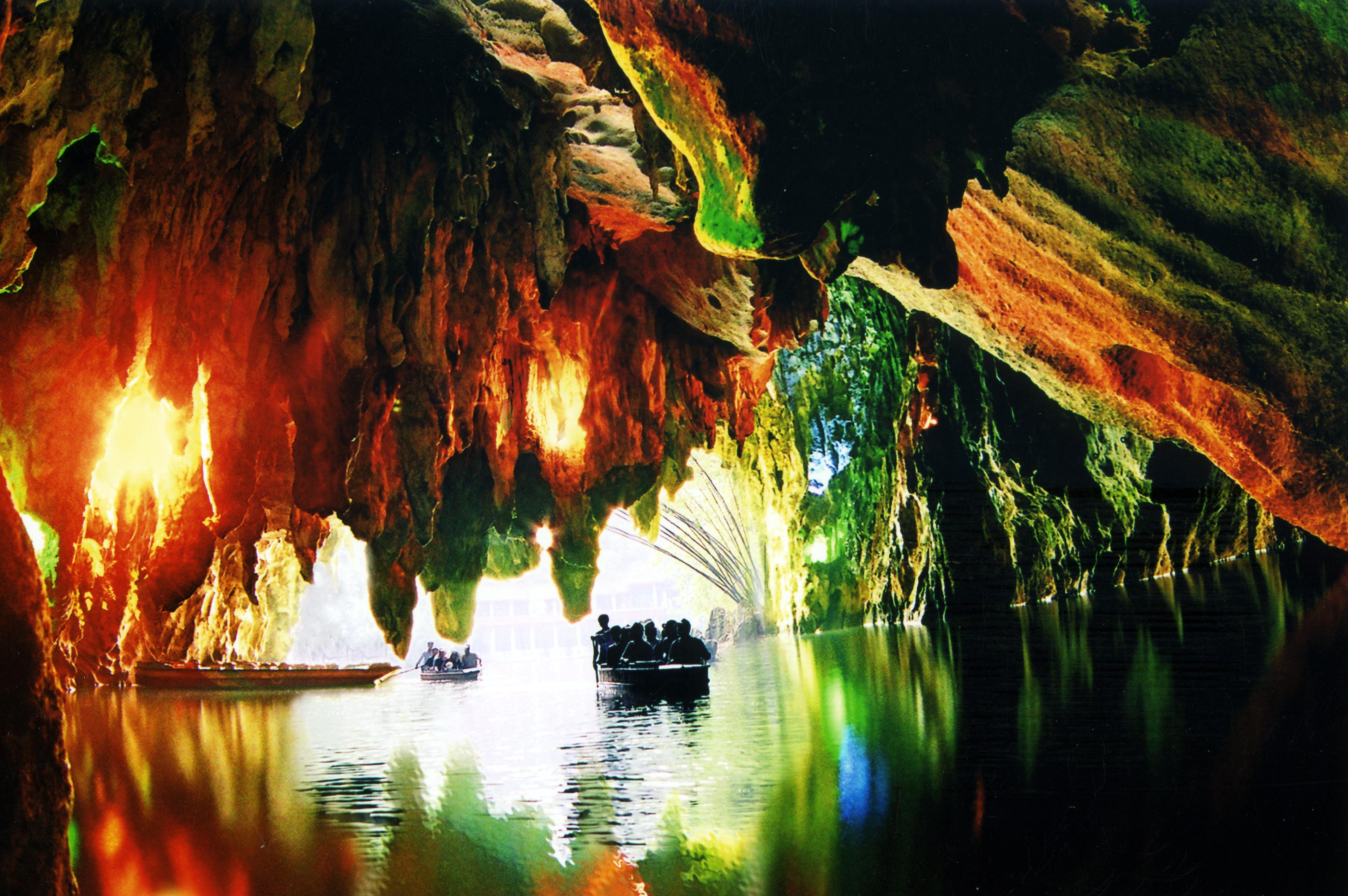 Boats gliding through the Longgong water cave near Anshun