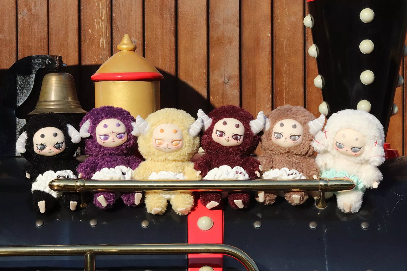 Lineup of custom designer plush toys with costumes and detailed character faces