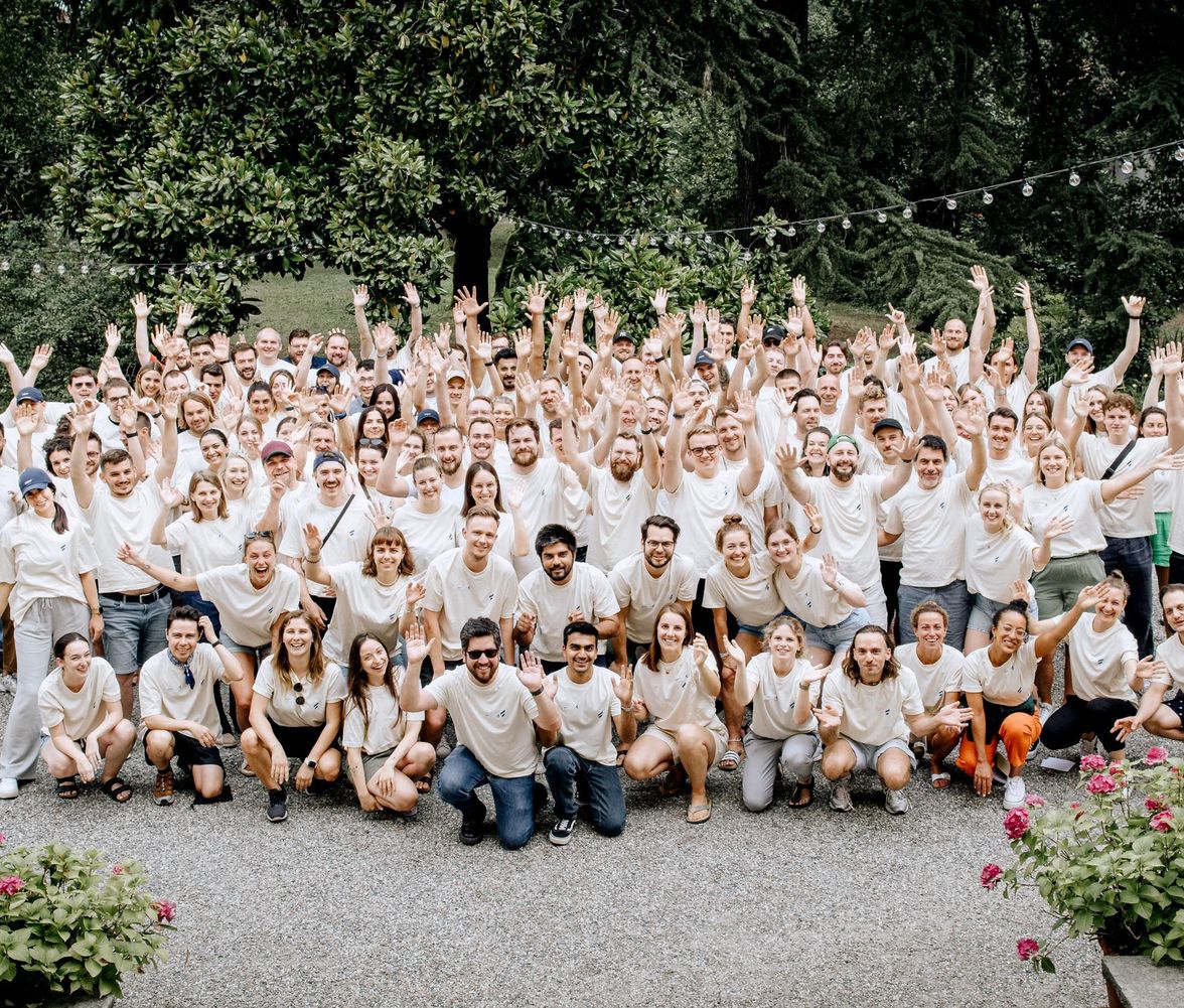 Company team building group in matching branded shirts outdoors