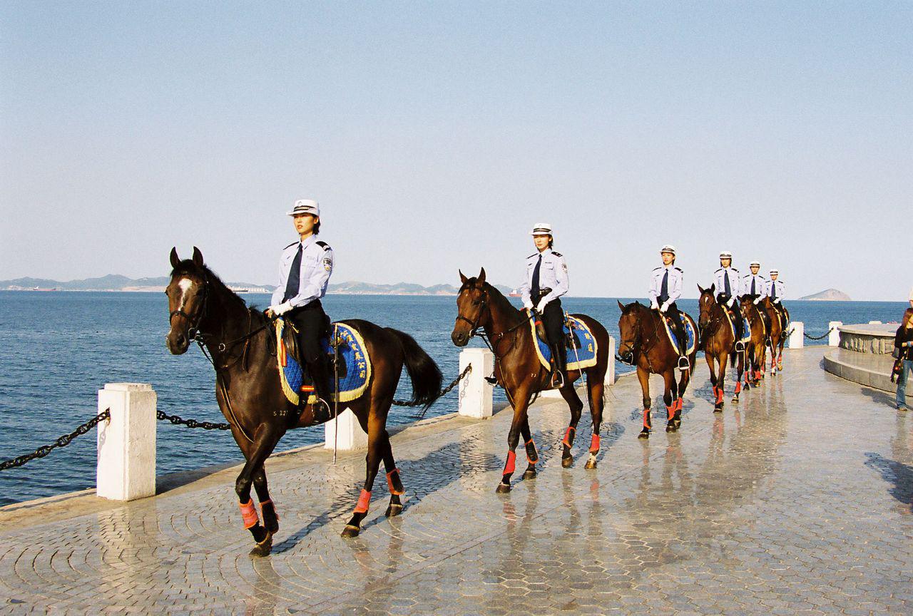 Female mounted police patrol on the Dalian seafront